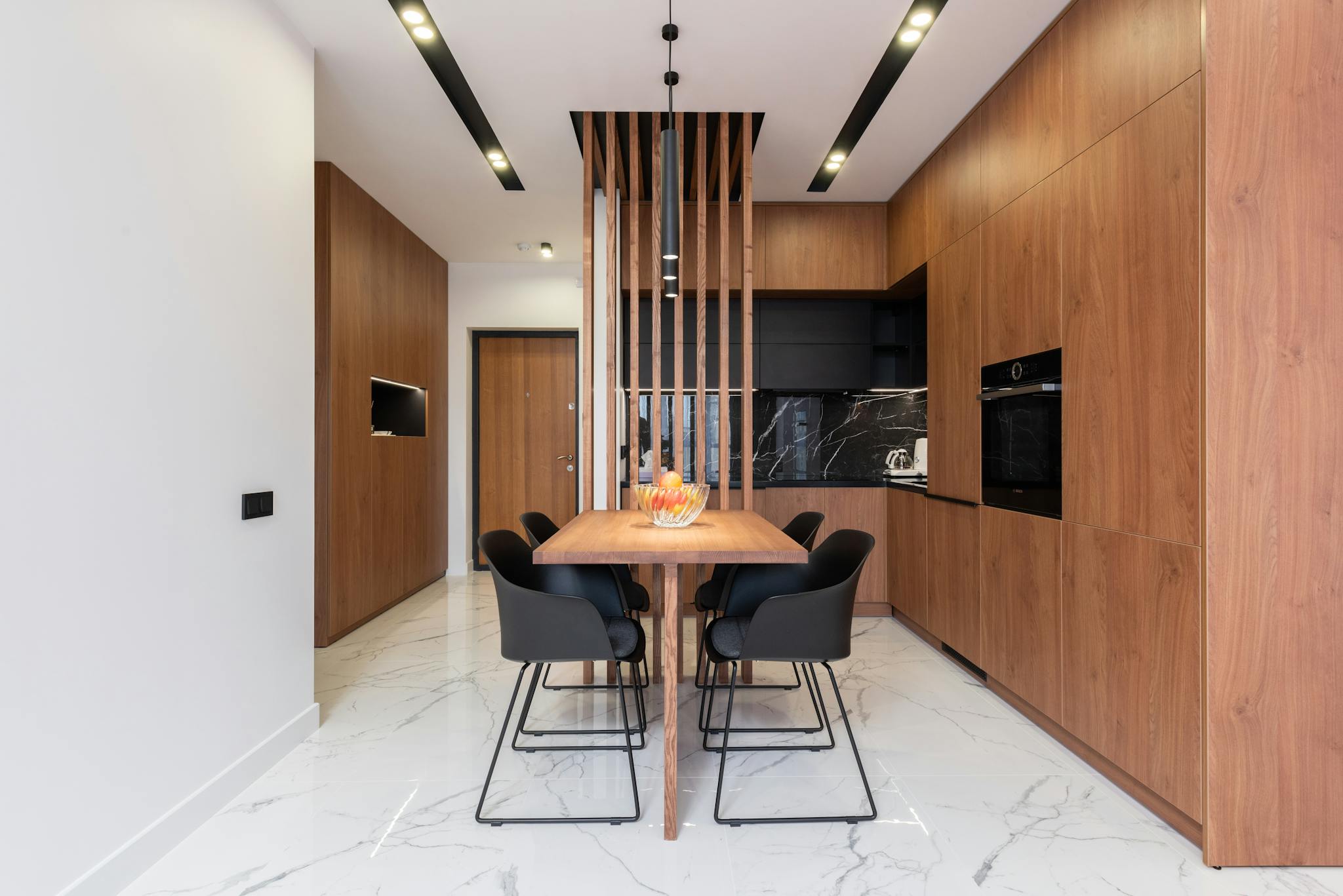 Stylish kitchen with wooden furniture and dining zone